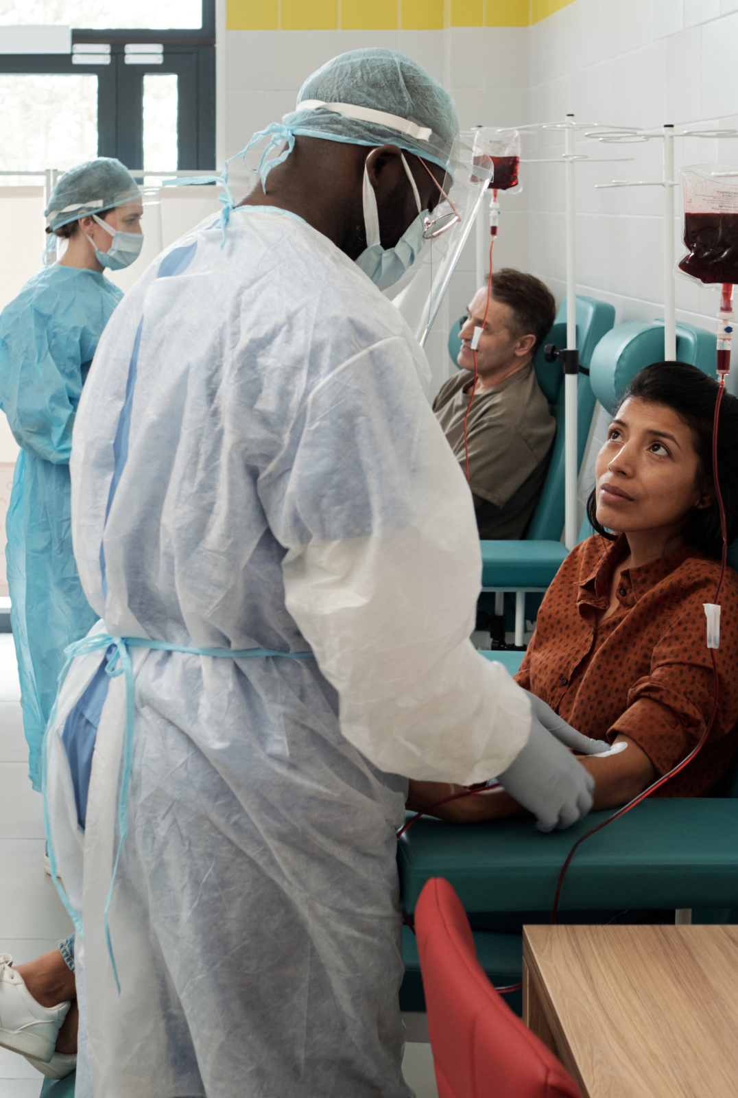 African clinicians and a patient in discussion in a South African clinic